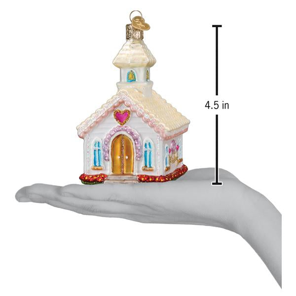Wedding chapel ornament on an open palm beside a 4.5 inch height marker