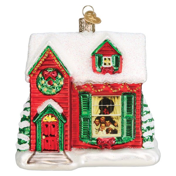 Norman Rockwell You're Home ornament, front view of a red farmhouse with snowy roof, wreath, and lit window, on white