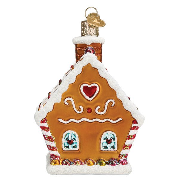 Gable end of the gingerbread cottage ornament with a red heart and chimney, on white