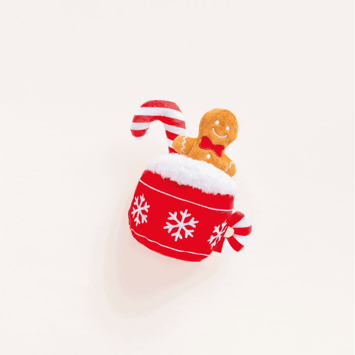Animated clip of the hot cocoa mug dog toy on a cream backdrop