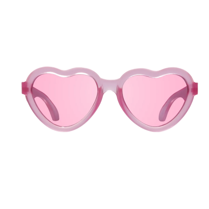 Fuchsia heart-shaped kids sunglasses shown from the front with pink lenses on a plain background.