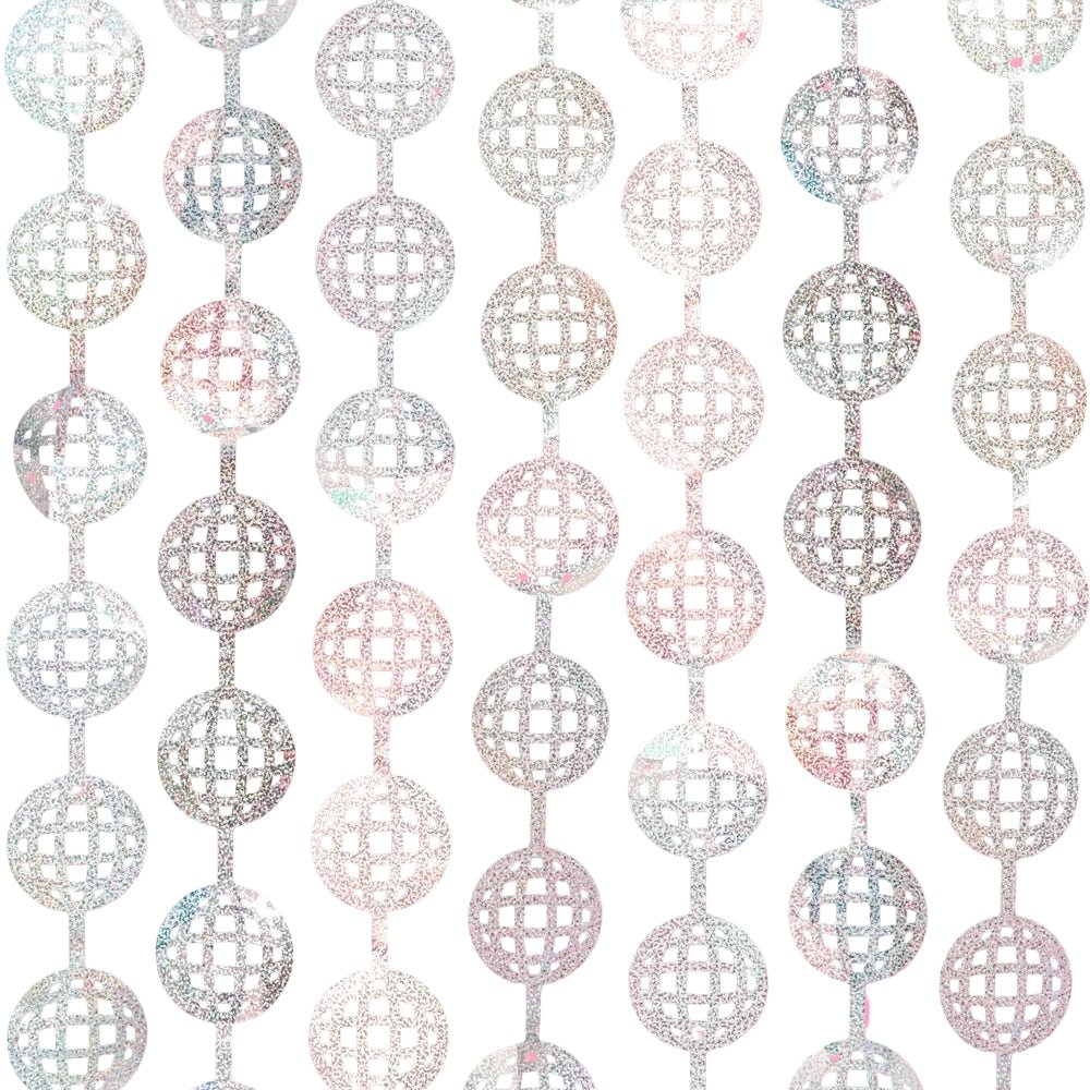 Silver disco ball foil curtain hung flat against a bright pink wall