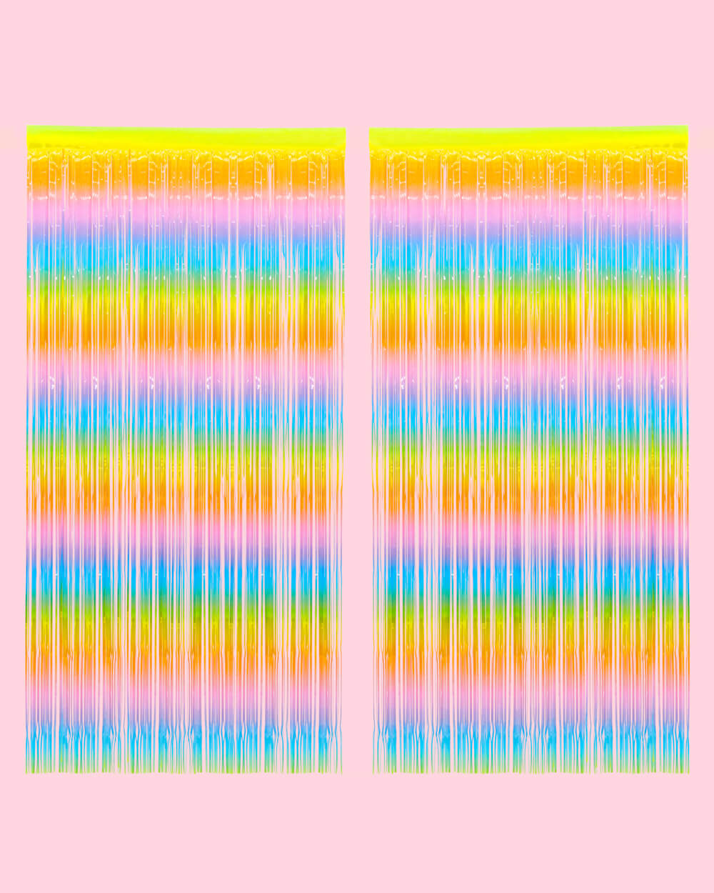 Two pastel rainbow fringe curtain panels hung side by side on a pale pink wall
