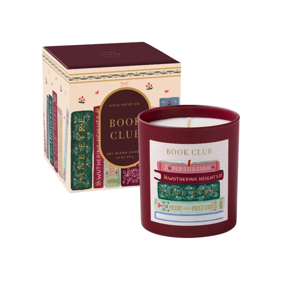 Book Club candle in burgundy glass vessel with painted book stack label beside illustrated bookshelf gift box