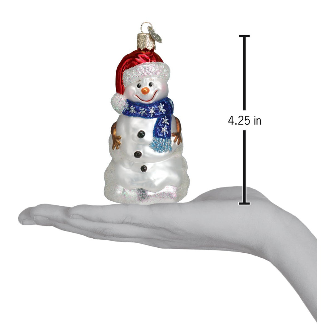 Happy snowman ornament on an open palm beside a 4.25 inch height marker