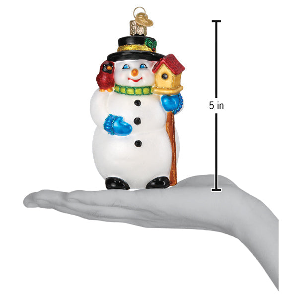 Snowman with cardinal ornament on an open palm beside a 5 inch height marker