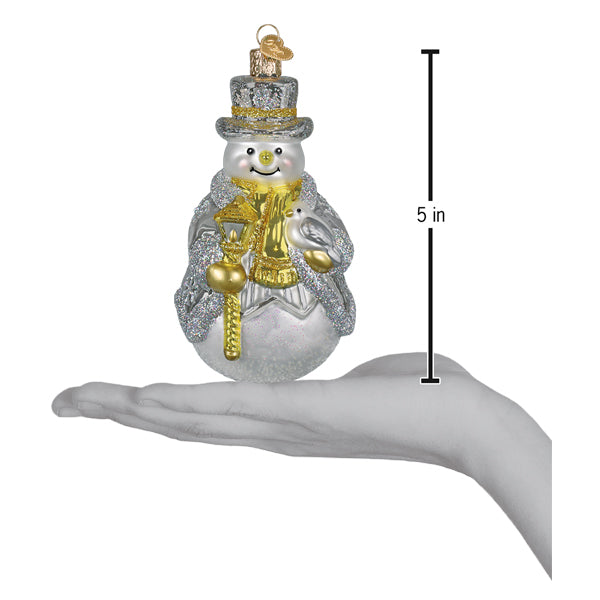 Sterling snowman ornament on an open palm beside a 5 inch height marker