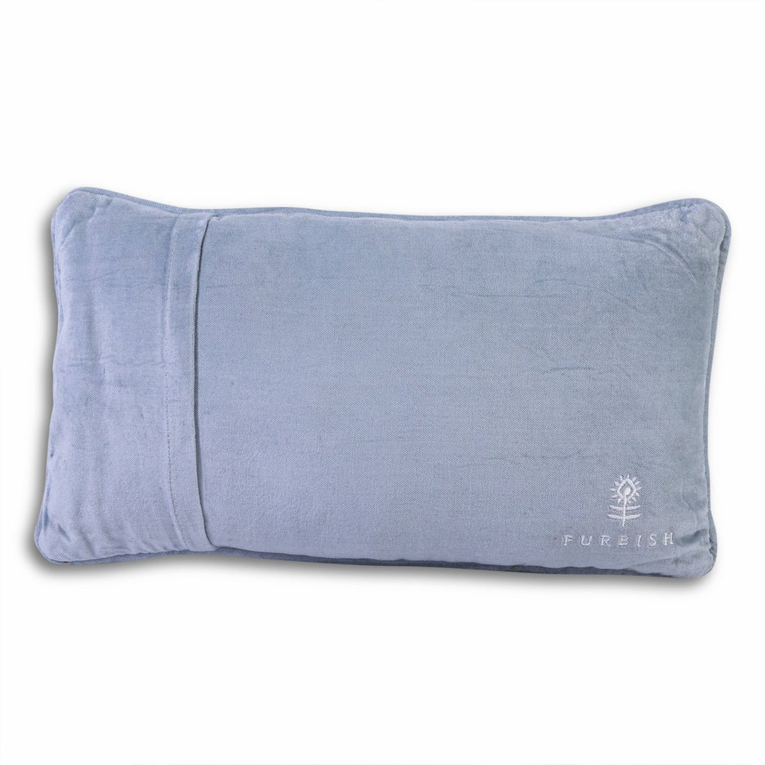 Periwinkle blue velvet back of a needlepoint throw pillow with an embroidered flower logo for home decor