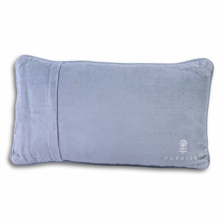Periwinkle blue velvet back of a needlepoint throw pillow with an embroidered flower logo for home decor