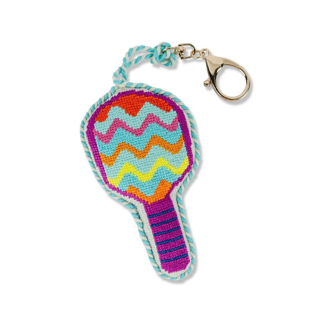 Colorful chevron needlepoint bag charm with a striped handle and gold clip for a party or fiesta gift