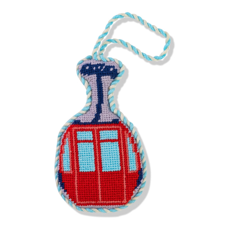 Ski lift gondola needlepoint ornament, front view of a red cabin with blue windows and light blue cord