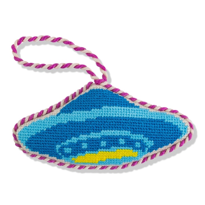 Blue UFO flying saucer needlepoint ornament with a yellow light ring and magenta twisted cord, front view