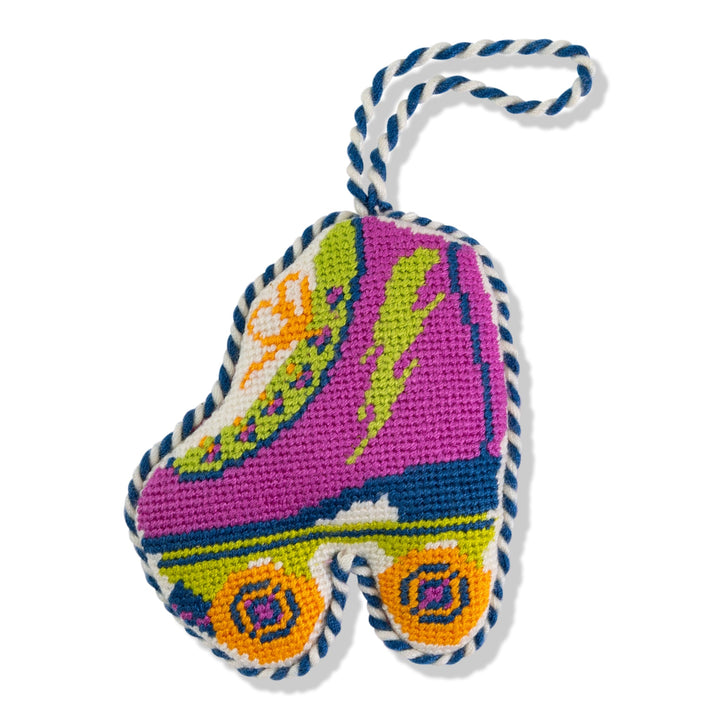Retro roller skate needlepoint ornament, front view in magenta with lightning bolt and orange wheels