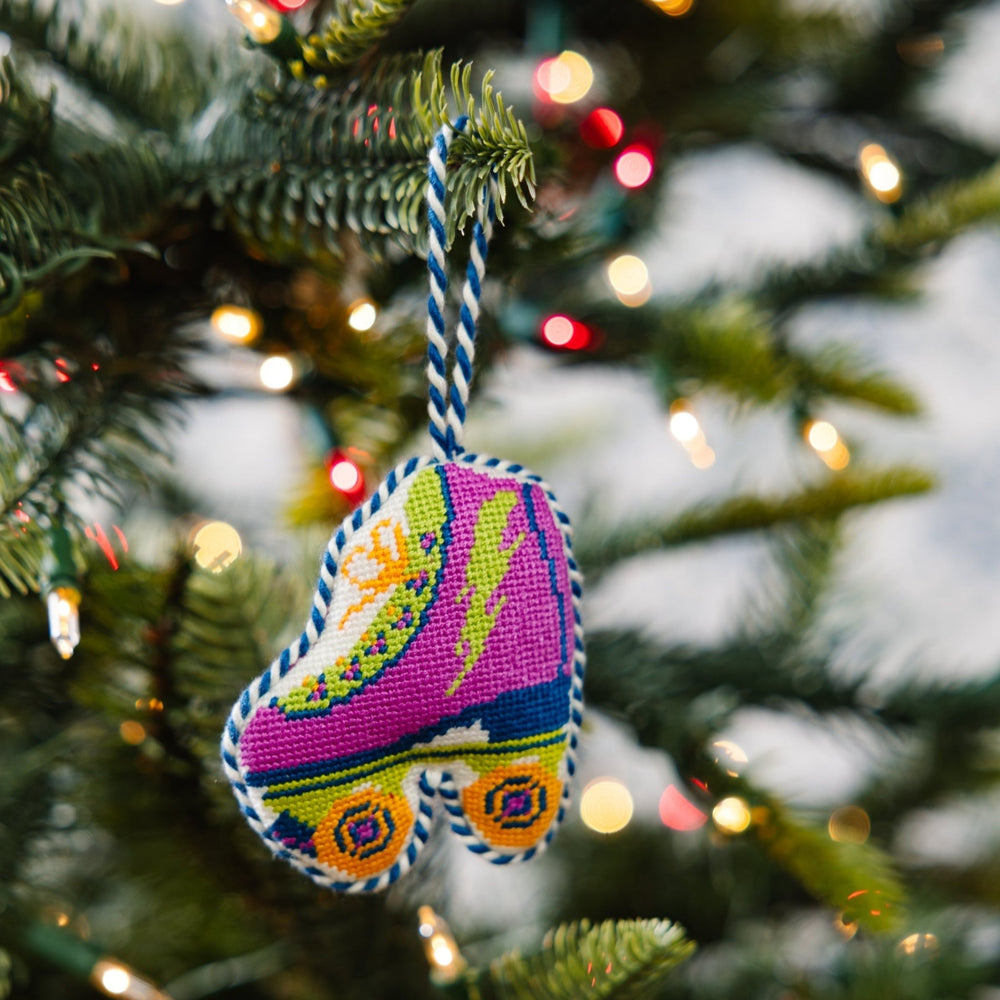 Roller skate ornament hanging on a green Christmas tree branch with twinkle lights