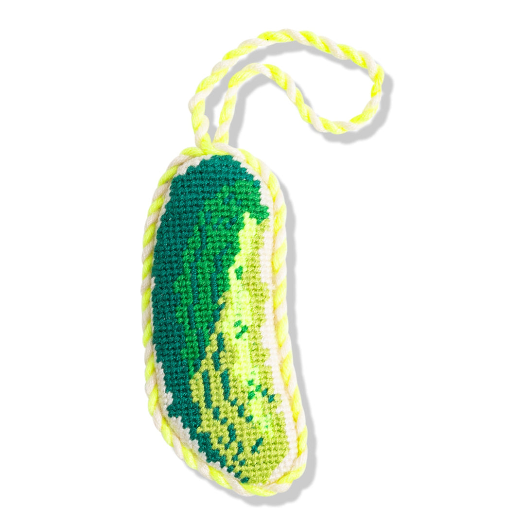 Green pickle needlepoint ornament with shaded stitching and a lime twisted cord, front view on white
