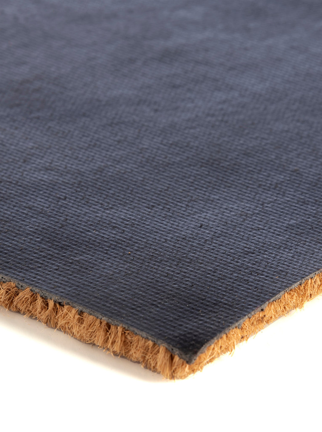 Close-up of the coir doormat thickness and backing
