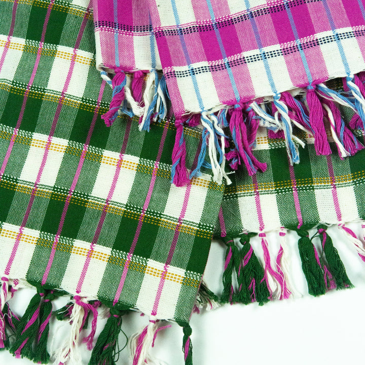 Green plaid and pink plaid San Andres towels overlapping to show their fringed hems