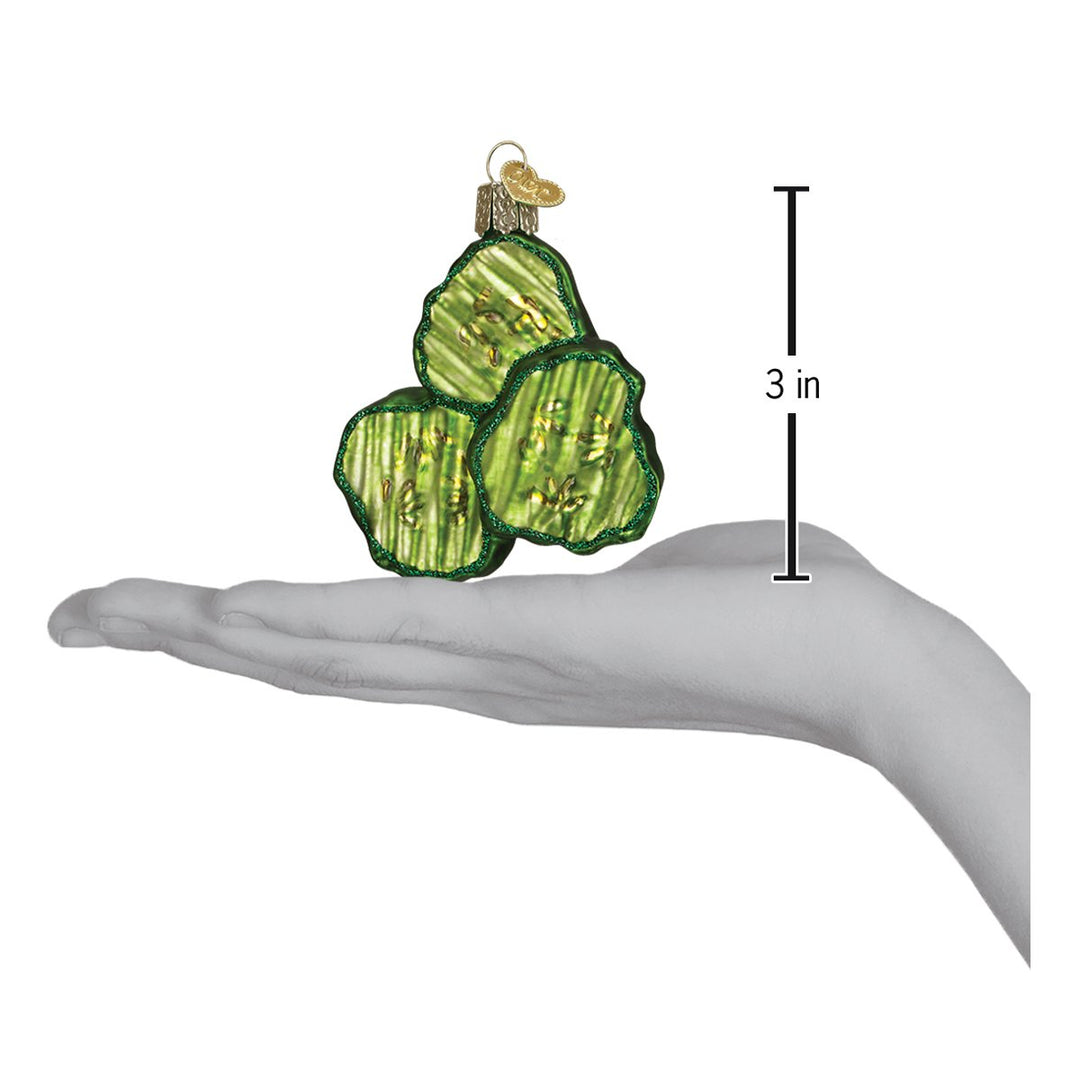 Pickle chips ornament on an open palm beside a 3 inch height marker