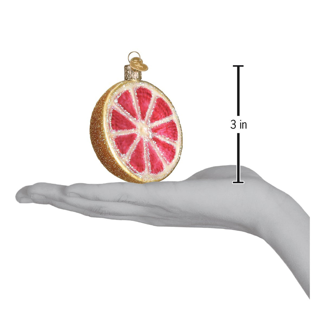 Grapefruit slice ornament on an open palm beside a 3 inch height marker