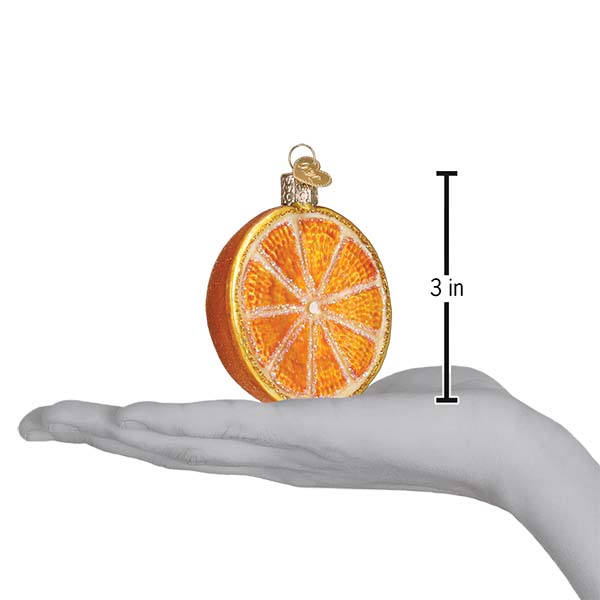 Orange slice ornament on an open palm beside a 3 inch height marker
