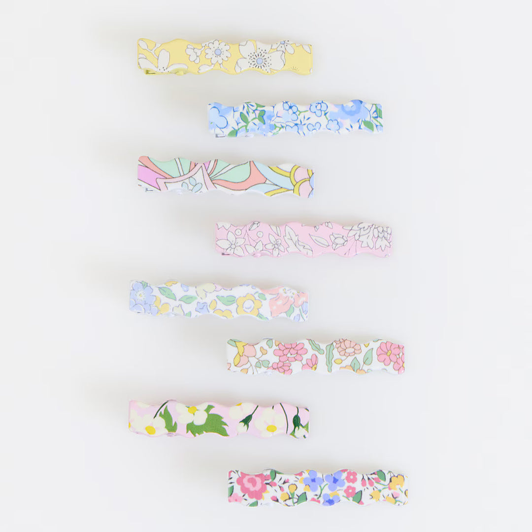 Eight Meri Meri x Liberty wavy hair clips with assorted pastel floral designs and a clear resin finish.