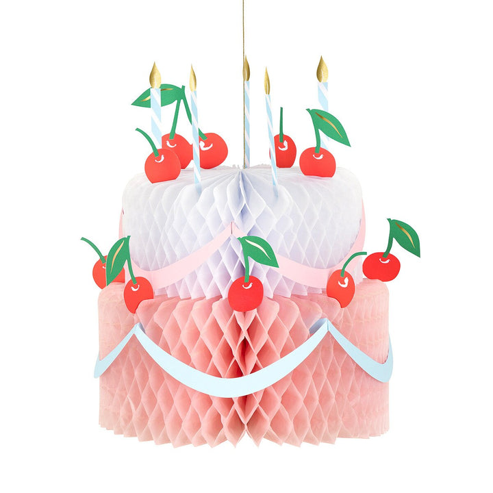 Meri Meri Honeycomb Birthday Cake decoration on white background, 3D tissue paper cake-shaped honeycomb party decoration