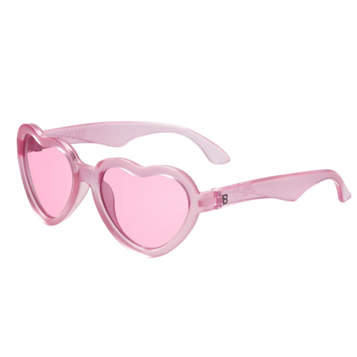 Kids fuchsia heart-shaped sunglasses with pink transparent lenses and bendable frames for beach and birthday fun, ages 0 to 5.