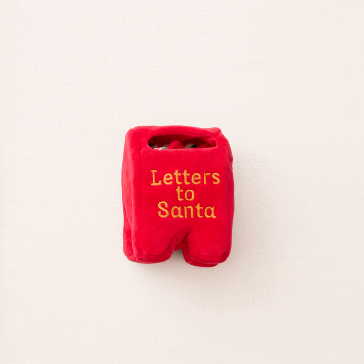 Animated clip of the Letters to Santa mailbox dog toy on a pale pink backdrop