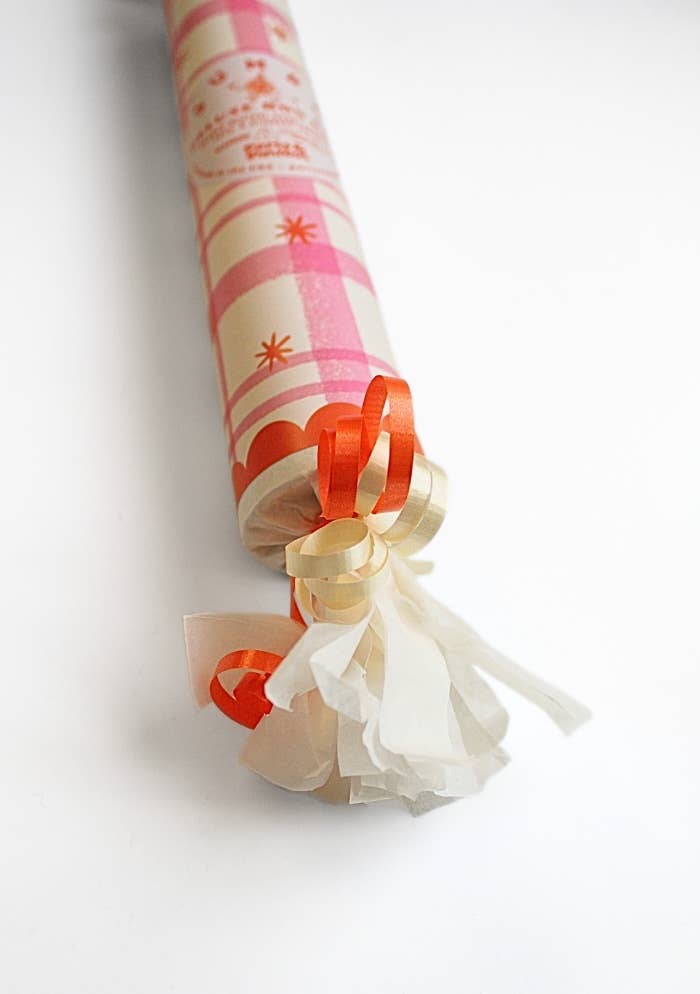 Close-up of the pink plaid bon bon orange curling ribbon and fringed end, ready for a kids' party
