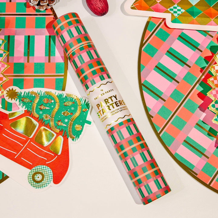 Plaid conversation game tube on a holiday table with plaid plates and a car-shaped napkin