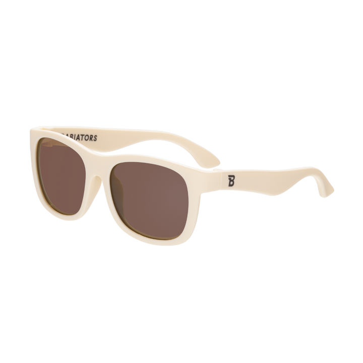 Kids cream aviator sunglasses with amber lenses and flexible frames for beach days and vacations, sized for ages 0 to 6 and up.