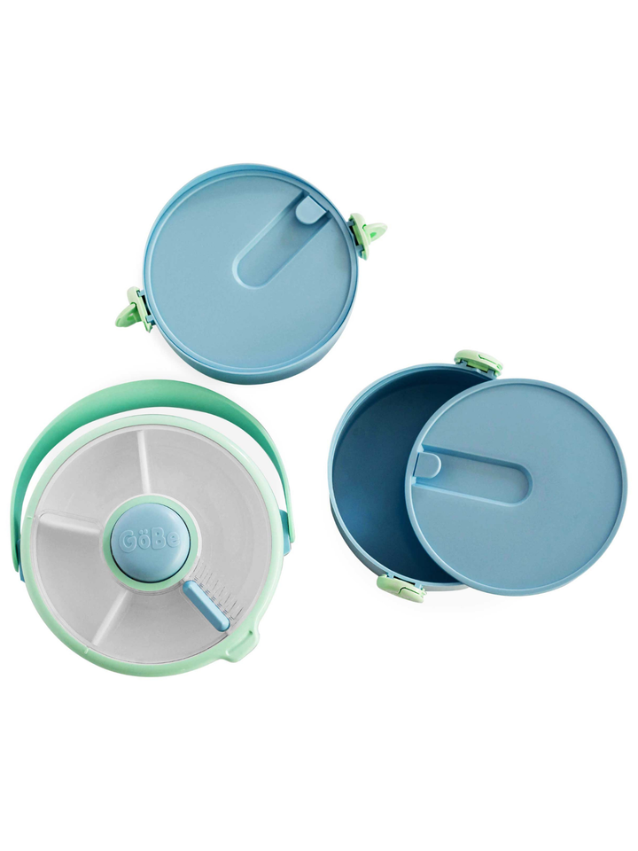 Blue Lunch Stack taken apart into its lid, snack spinner, and two meal compartments