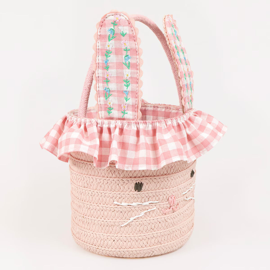 Pink paper raffia bunny Easter basket with floral embroidered gingham ears, a bunny face, and ruffled lining.