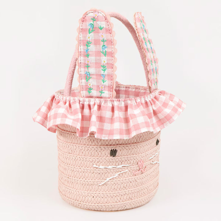 Pink paper raffia bunny Easter basket with floral embroidered gingham ears, a bunny face, and ruffled lining.