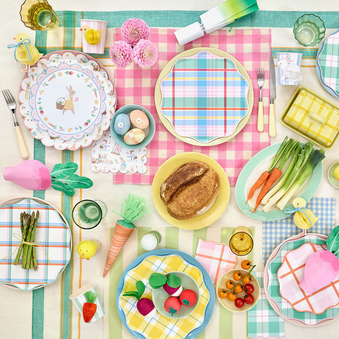 Pastel-striped Easter paper cups with 3D honeycomb chick, bunny, and carrot decorations on a spring party table.
