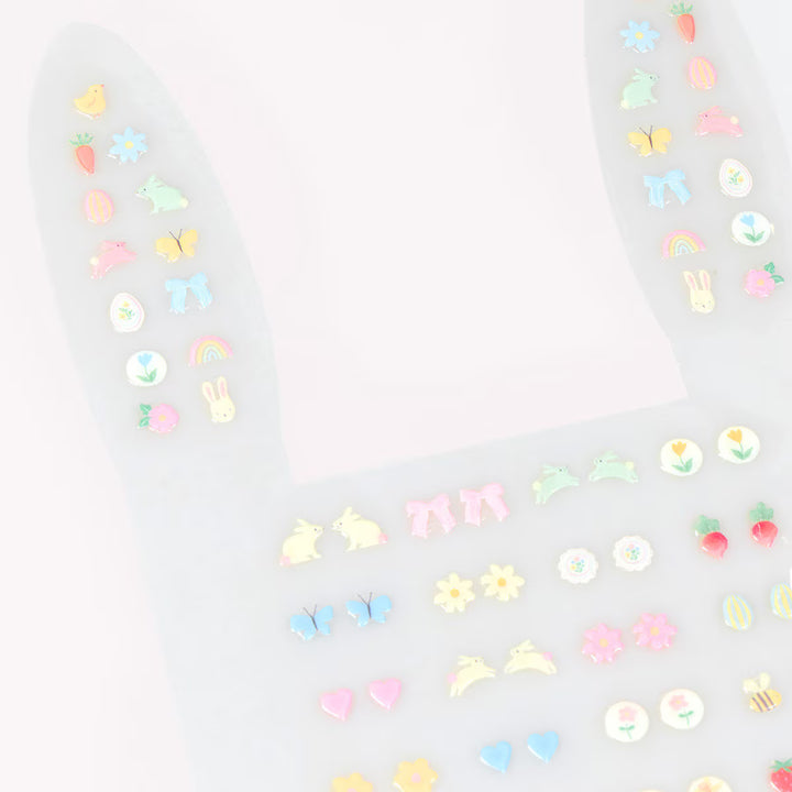 Pastel Easter stick-on earrings with bunny, chick, butterfly, carrot, and flower designs arranged in matching pairs.