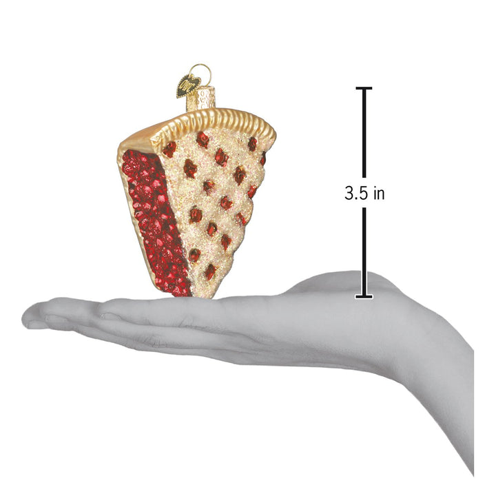 Cherry pie ornament on an open palm beside a 3.5 inch height marker