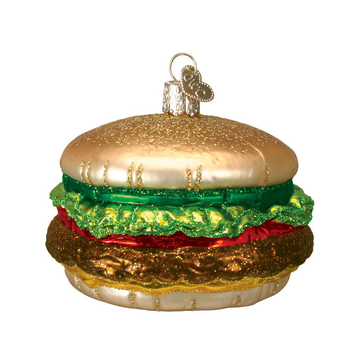 Cheeseburger ornament with a glittered golden bun, green lettuce, red tomato, and brown patty, front view