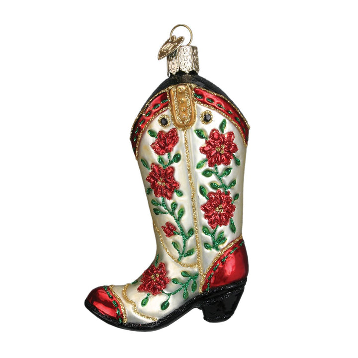Ivory cowgirl boot ornament with red poinsettias, green leaves, red toe, and black heel, on white