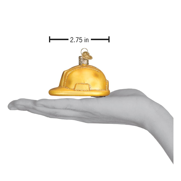 Hard hat ornament on an open palm beneath a 2.75 inch width marker