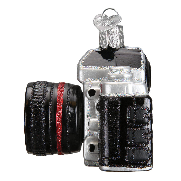 Side view of the camera ornament showing the lens barrel and textured black grip
