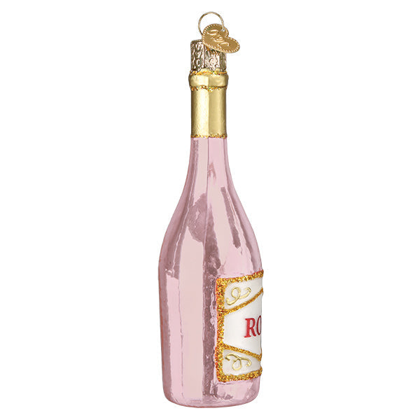 Side view of the pink rosé bottle ornament showing the curved label edge and gold cap