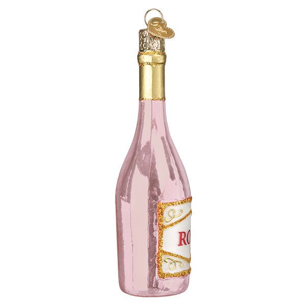 Side view of the pink rosé bottle ornament showing the curved label edge and gold cap