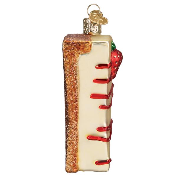 Cheesecake ornament side edge, cream filling with red drizzle and a strawberry on top