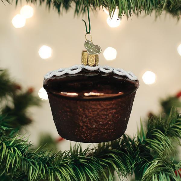 Hostess Cupcake glass ornament hanging on a Christmas tree with warm bokeh lights