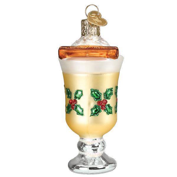 Front of the eggnog mug ornament with a cinnamon stick resting on whipped cream and a holly band, on white