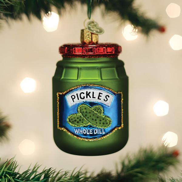 Jar of pickles glass ornament with a Whole Dill label hanging on a lit Christmas tree