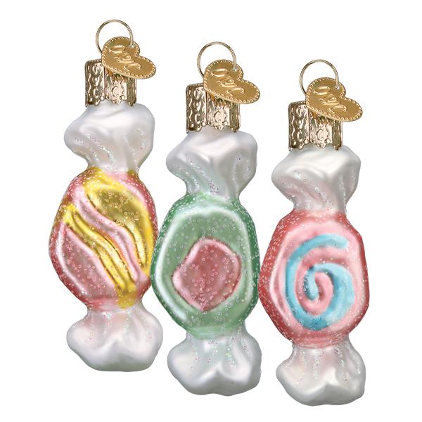 Set of three salt water taffy glass ornaments in pink, mint green, and blue swirl, side by side on white