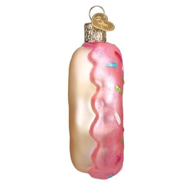 Side profile of the donut ornament with the pink icing dripping over the edge