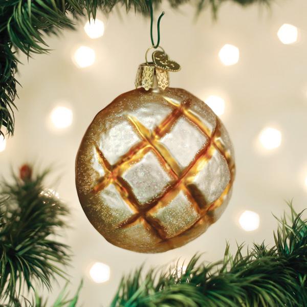 Sourdough boule glass ornament hanging on a lit Christmas tree